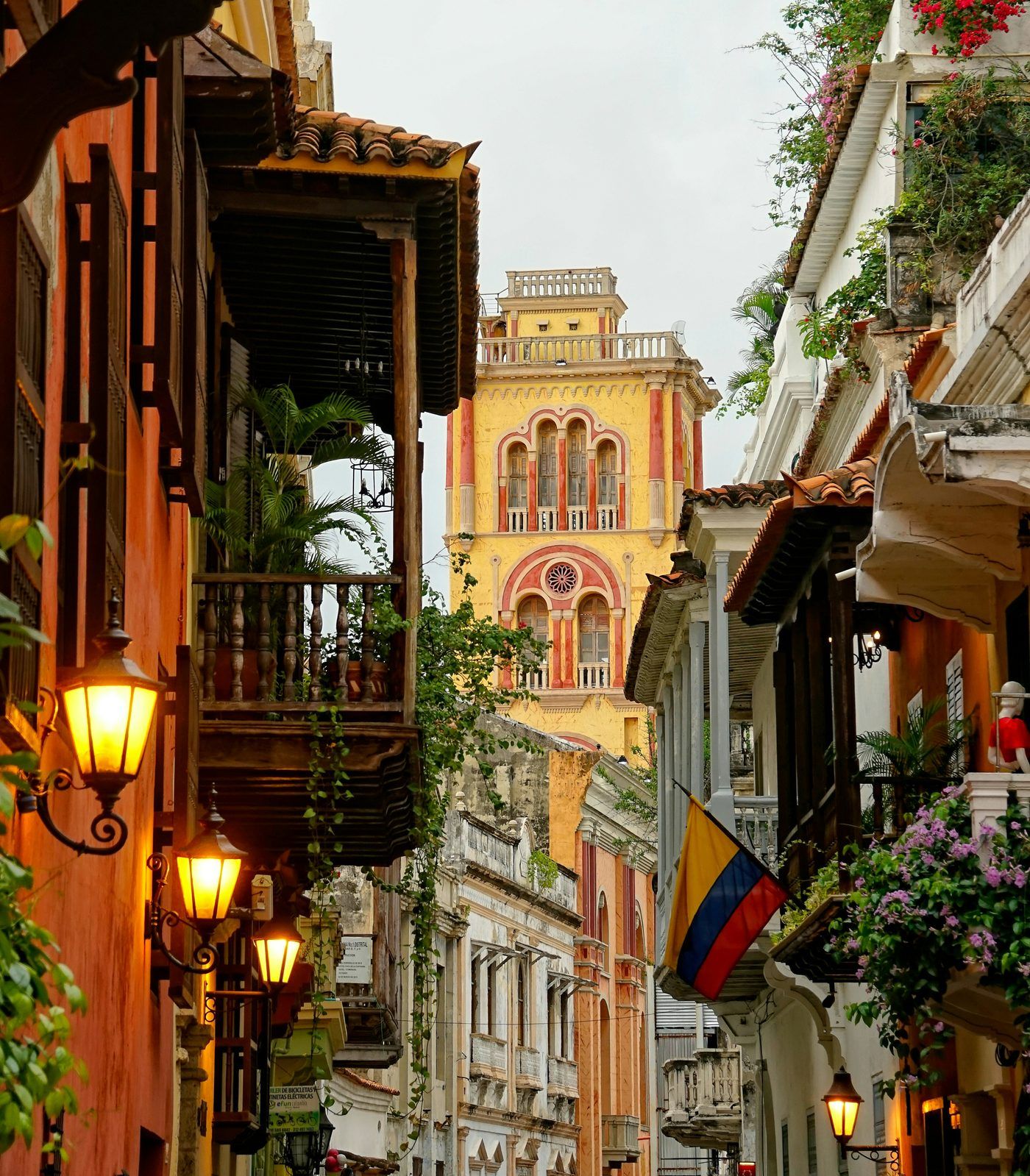 Cartagena colonial street with lanterns and Colombian flag